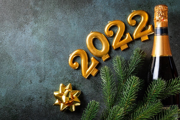 2022 numbers with champagne bottle and decor. Happy new year and festive concept. Top horizontal view copyspace. New Year Flatly. Christmas flatlay. New year 2022. New year concept.