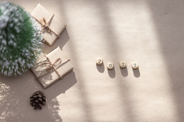 2022 numbers on wooden cubes on craft paper background, copy space, flat lay.