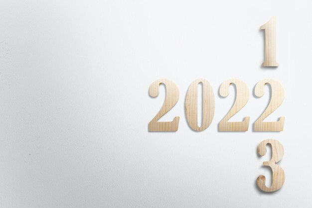 Photo 2022 with white wall background. happy new year 2022