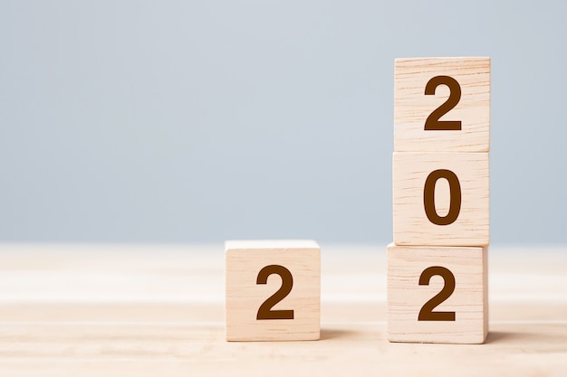 2022 wooden cube blocks on table background. Resolution, plan, review, goal, start and New Year holiday concepts