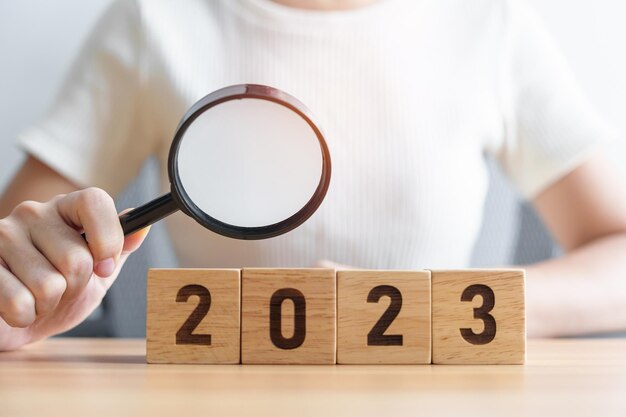 2023 block with magnifying glass SEO Search Engine Optimization hiring Advertising Idea Strategy marketing Keyword Content and New Year start concepts