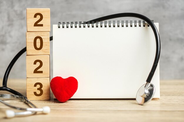 2023 Happy New Year for healthcare Insurance Wellness and medical concept Stethoscope and blank notebook for copy space your text