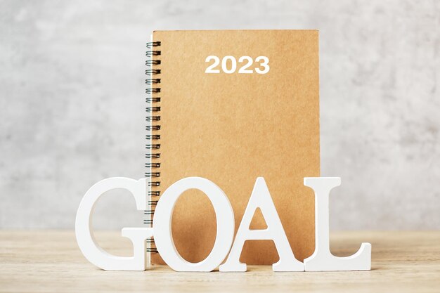 2023 Happy New Year with notebook and wooden number goal countdown Resolution Plan Action and Mission Concept