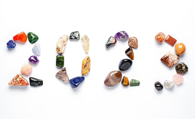 2023 inscription of mineral stones on a white background The concept of the New Year