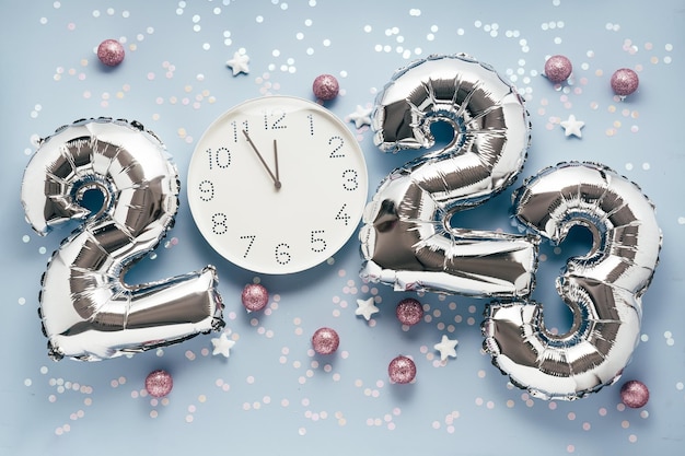 2023 New Year Celebration silber balloon numbers on blue with confetti