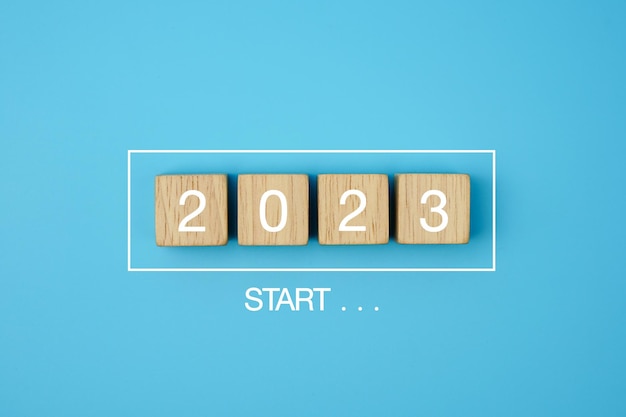 2023 New Year . Start new year 2023 with goal plan, progress Bar with wooden blocks 2023 on blue