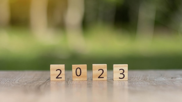 2023 nieuwjaar doel planning idee hout blok kubus op houten tafel met nieuwjaar 2023 en doel icoon zakelijke visie