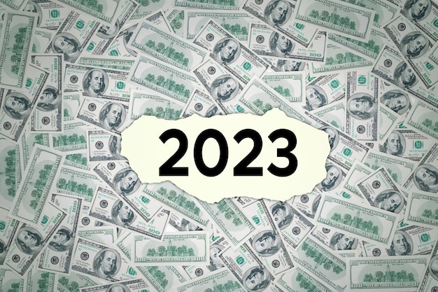 2023 number on torn paper with money background