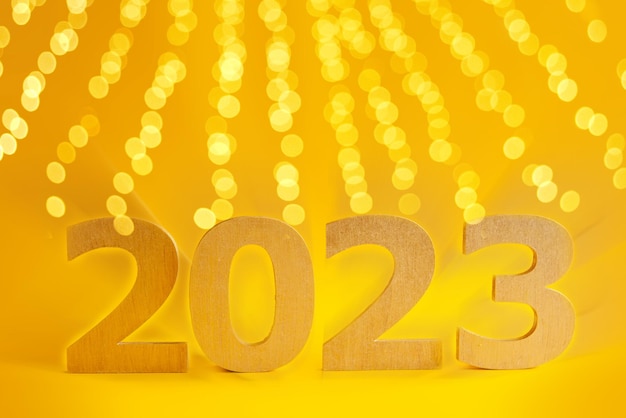 2023 Year Golden Number Text on Yellow Background