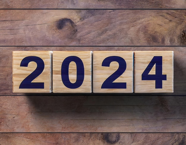 Foto la vigilia del capodanno del 2024 blocchi di legno flip change conto alla rovescia a mano a partire dalla fine del 2023 programma d'azione