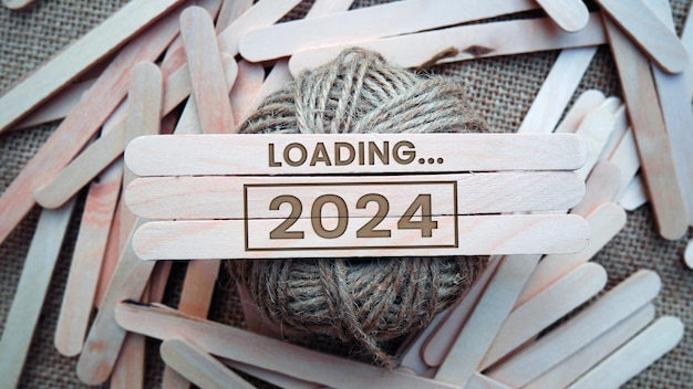 2024 New Year Loading Loading bar with wooden blocks 2024 on blue background