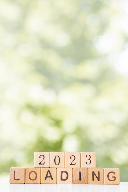 2024 New Year Loading Loading new year 2023 with wood cube in progress bar creative background