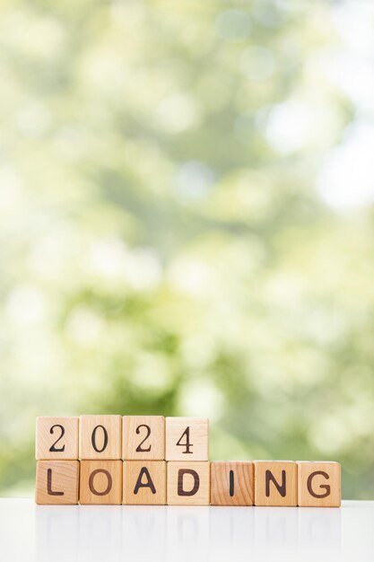 2024 New Year Loading Loading new year 2023 with wood cube in progress bar creative background