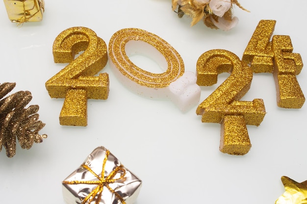 2024 written with golden letters on white background with ornaments