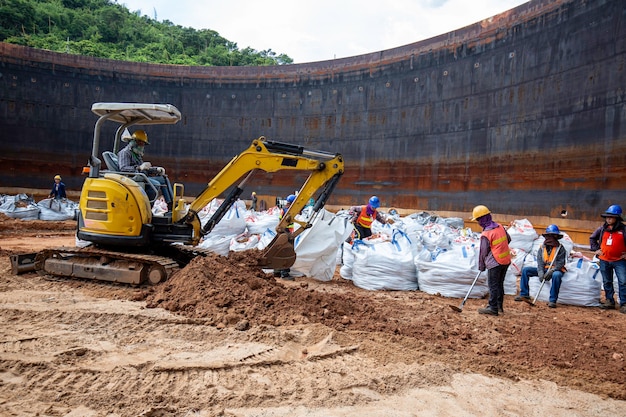 21 September,2020 chonburi, Thailand Group of worker and construction engineer excavation at bottom tank oil