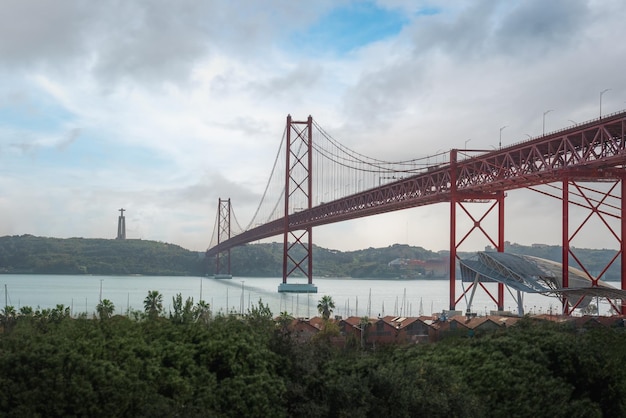 25 de Abril Bridge Sanctuary of Christ the King skyline and Tagus River Rio Tejo Lisbon Portugal