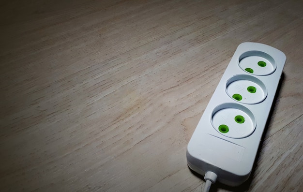 3 Outlet Extension Cord On A Wooden Surface