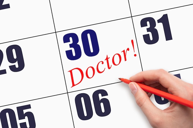 30th day of the month Hand writing text DOCTOR on calendar date