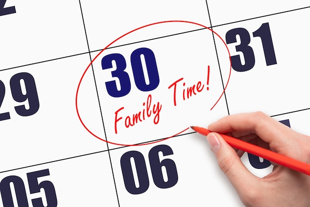 30th day of the month Hand writing text FAMILY TIME and circling the calendar date