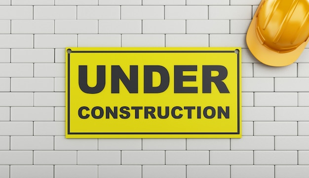 Photo 3d under construction sign on brick wall.