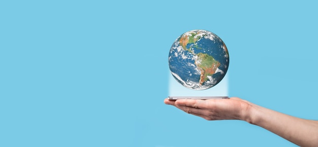 3D Earth planet globe in man, woman hand, hands on blue background.