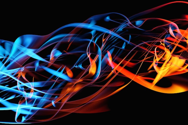 Photo 3d illustration orange and blue abstract cloud of smoke pattern on a black isolated background