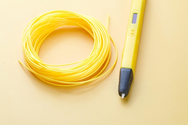 3d pen for creating volume plastic figures isolated on yellow background