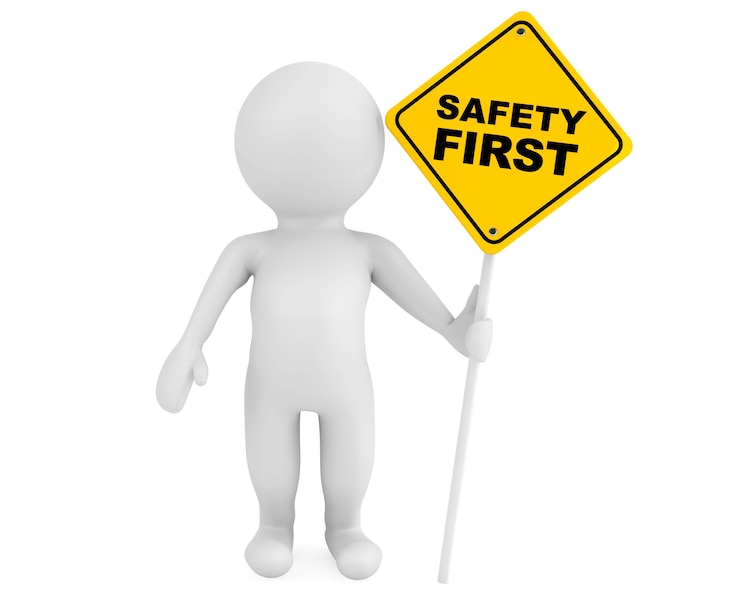 Photo 3d person with safety first traffic sign on a white background