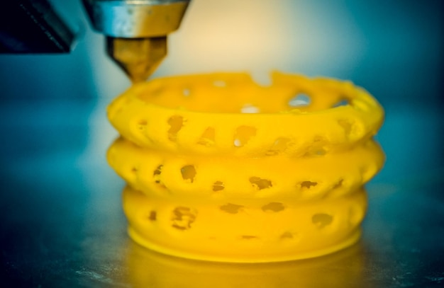 3d printer printing objects yellow form closeup