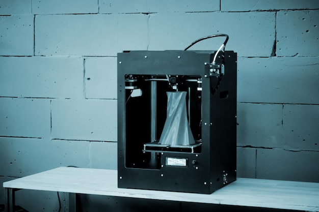 3D printer working close up Automatic three dimensional 3d printer performs plastic Modern 3D printer printing an object from the hot molten Concept progressive additive technology for 3d printing