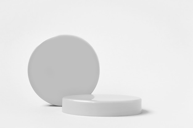 Photo 3d render grey pedestals and circle podium for cosmetics product on white background