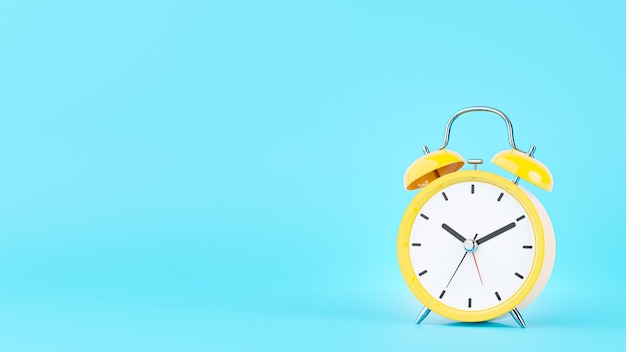 3d render of yellow alarm clock on blue background