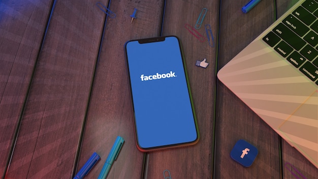 3D rendering of a smartphone displaying the facebook app logo on a wooden desktop