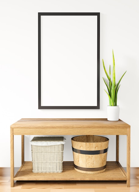 Photo 3d rendering white poster frame mockupon the white wall,table,basket and plant on the wooden floor ,raw concrete wall