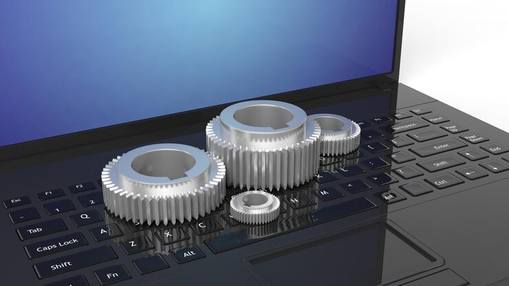 Photo 3d silver cogwheels on laptop keyboard isolated on white background