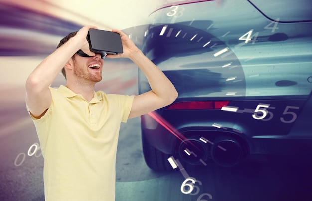 3d technology, virtual reality, entertainment and people concept - happy young man with virtual reality headset or 3d glasses playing car racing game over tachometer and street race background