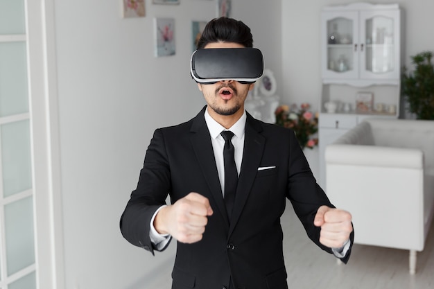 3d vision technology, video game simulation. Young man in suit and virtual glasses. Digital vr device