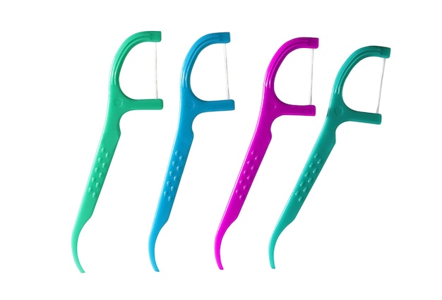 4 Dental Floss Picks (Plastic) isolated on a white background. (Green, Blue, Pink) Dental floss with handle, easy to use.