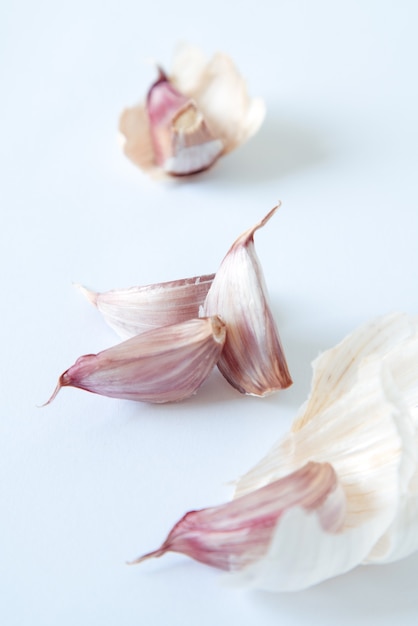 4 parts of a pink garlic on a white background