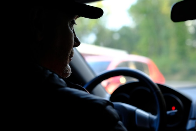 40 years handsome caucasian man sitting in a car view from rear seat