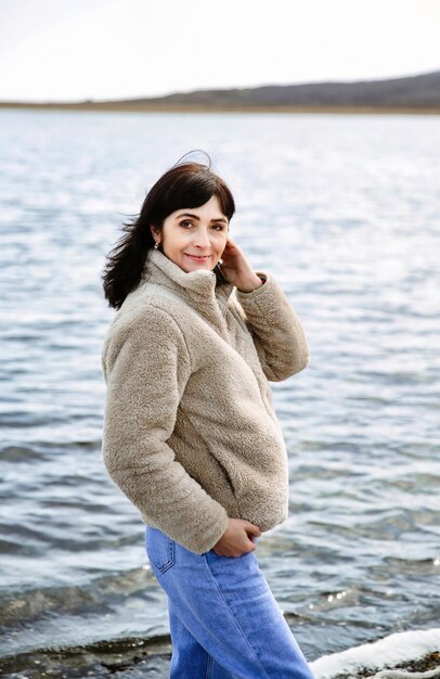 49 year old Russian woman smiling looking at the camera on an early spring day