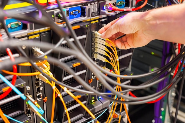 4K Image of IT Engineer Working with Servers and Storage in a Data Center SAN Enclosure