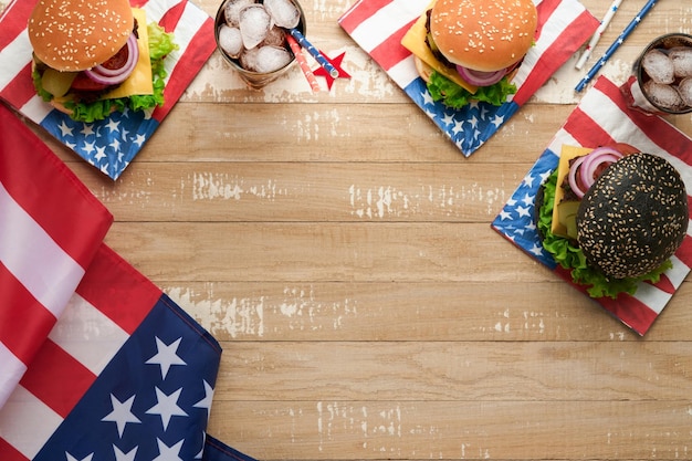 4th of July American Independence Day traditional picnic food American Burger and cocktail American flags and symbols of USA Patriotic picnic holiday on white wooden background Top view