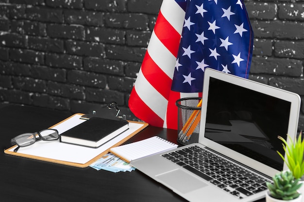 4th of july american independence day usa flags decorations in office desk with computer