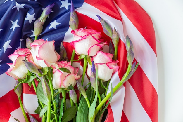 4th of july independence day usa. american flag and flowers roses for memorial day concept