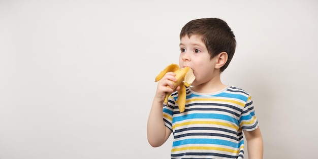 A 4yearold boy eats a banana