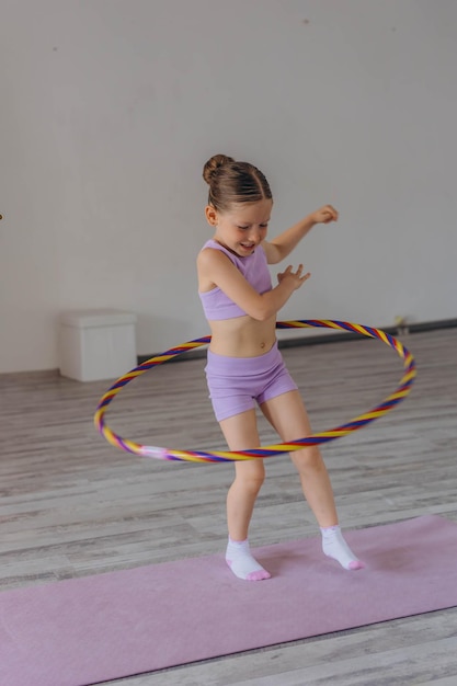 5 year old girl spins a gymnastic hoop