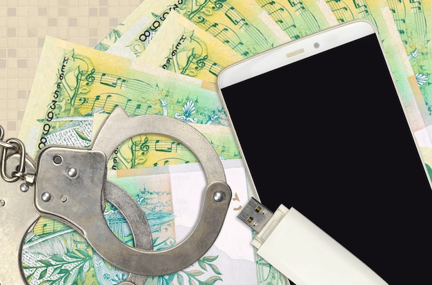 50 Belorussian rubles bills and smartphone with police handcuffs