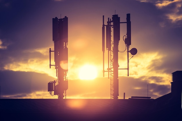 5g and communication tower Silhouette of communication tower on rooftop evening