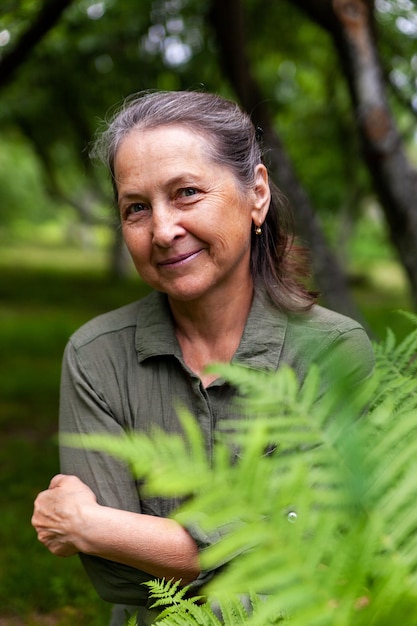 60yearold woman in green dress outdoors in summer